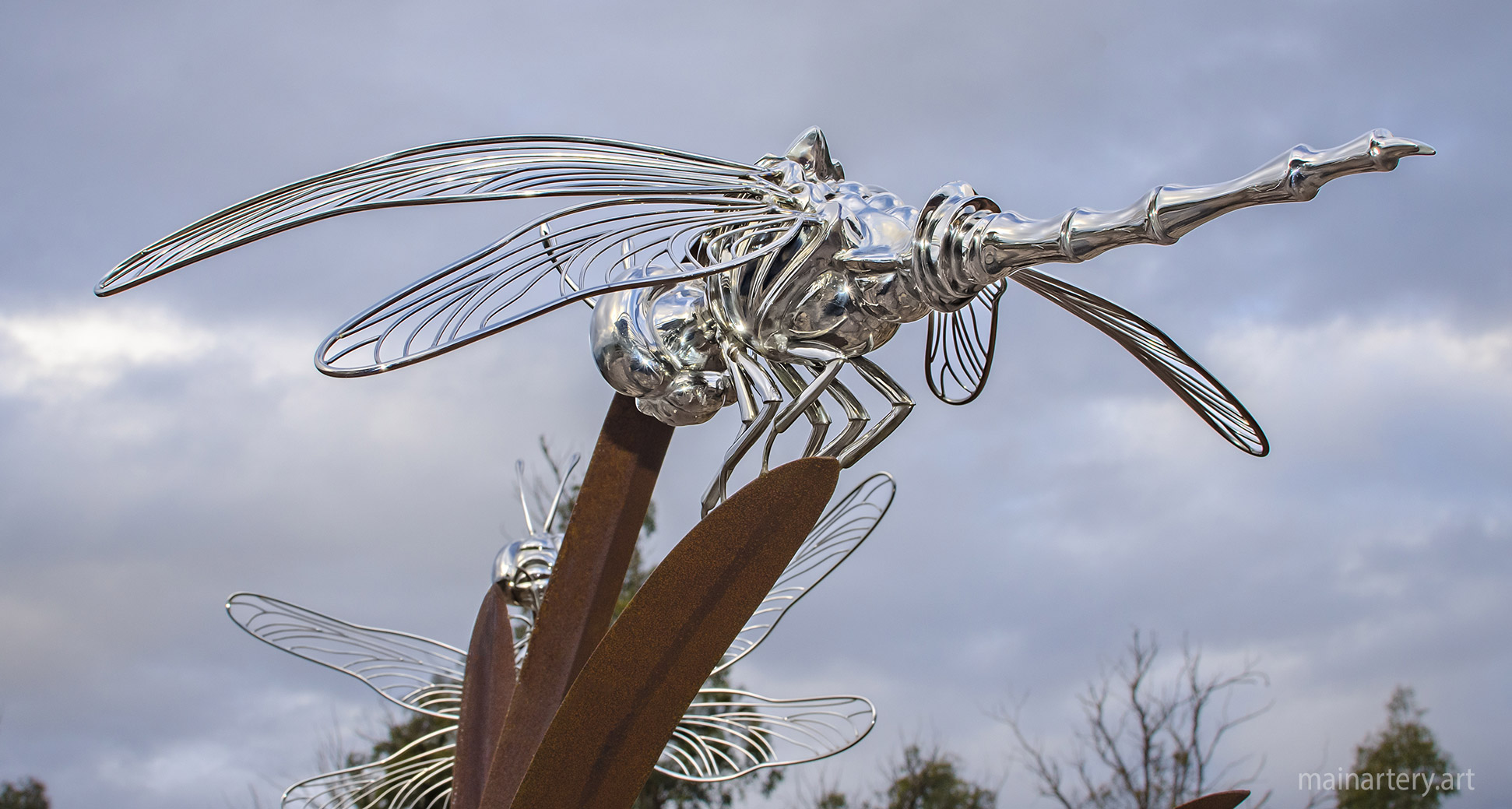 large corten steel realistic dragonfly landscape art image